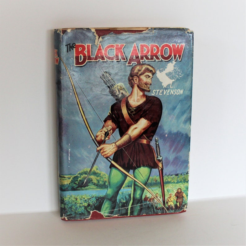 May include: A vintage paperback book cover featuring a colorful illustration of a man with a bow and arrow. The book title is "The Black Arrow" by R.L. Stevenson.