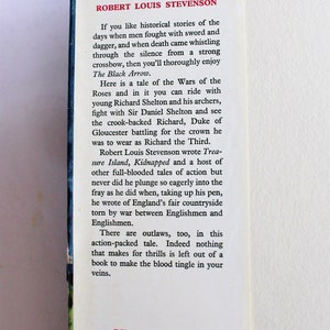 May include: A vintage book cover with a red title "The Black Arrow" by Robert Louis Stevenson. The text describes a historical tale of the Wars of the Roses, with outlaws, battles, and adventure.