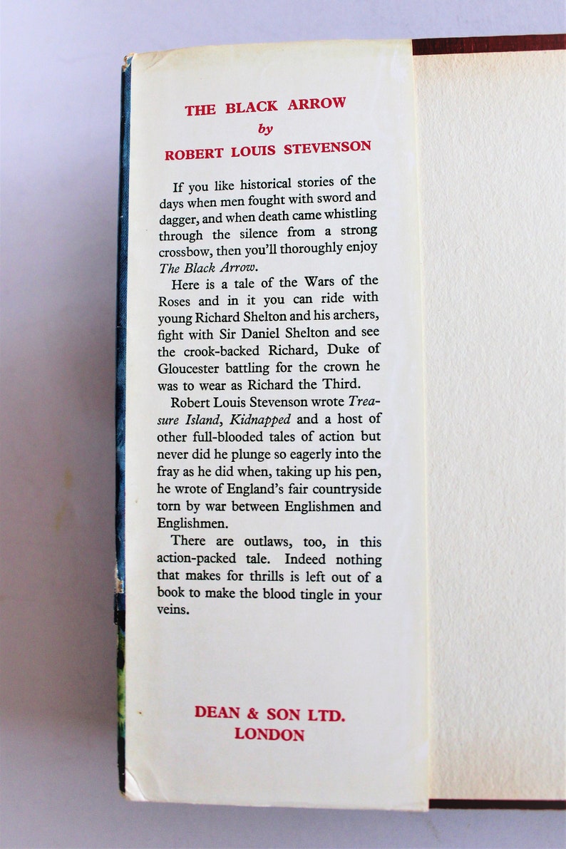 May include: A vintage book cover with a red title "The Black Arrow" by Robert Louis Stevenson. The text describes a historical tale of the Wars of the Roses, with outlaws, battles, and adventure.