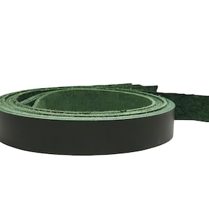May include: A coiled roll of dark green leather strips. The leather has a smooth surface on one side and a textured finish on the other. The image is set against a plain white background, emphasizing the product's colour and texture.