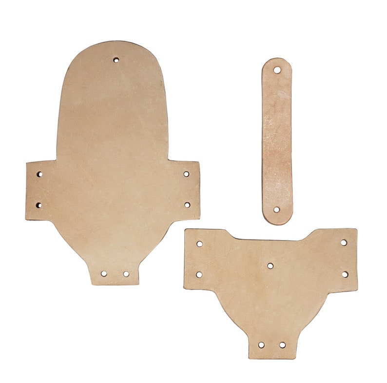 May include: Three pieces of brown leather cut out for a DIY leather craft project. The pieces are shaped like a rectangle, a teardrop, and a rounded rectangle.