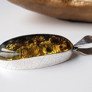 Vibrant green Baltic amber and silver pendant, Artistic Baltic amber pendant with a leaf texture setting, Large amber pendant with sparkles