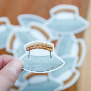 May include: A set of stickers featuring a vintage-style,  grey,  metal,  curved knife with a wooden handle. The stickers are white with a black outline.