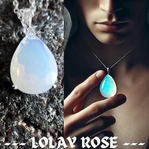 May include: A silver chain necklace with a teardrop-shaped pendant made of iridescent opal. The pendant is a light blue color with a hint of pink and green.