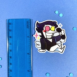 May include: A cartoon sticker of a character with black hair, a black suit, and a white shirt. The character has a large, toothy grin and is holding a microphone. The sticker is on a blue background.