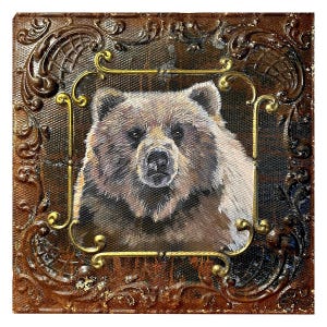 May include: A painting of a brown bear's face framed in a gold and brown ornate frame.