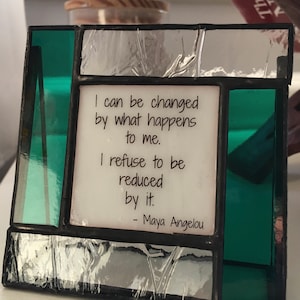 Maya Angelou's hopeful words on colorful stained glass frame.