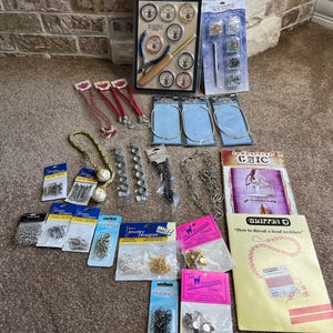 May include: Assortment of jewelry making supplies including beads, clasps, chains, wire, and tools.  The packaging includes instructions on how to thread a bead necklace.  The packaging is in various colors including red, blue, yellow, and white.