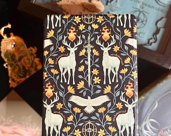 May include: A black and gold patterned book cover with a fantasy theme. It features white deer, yellow flowers, and a sword. The cover also includes the text "to whatever end". The design is symmetrical and detailed.