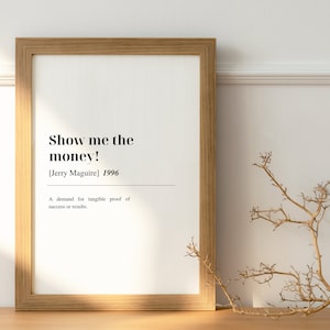 May include: A framed print with a white background and black text that reads "Show me the money! [Jerry Maguire] 1996" and "A demand for tangible proof of success or results."