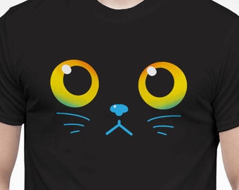 May include: A black t-shirt with a cartoon cat face printed on the front. The cat has yellow eyes, a blue nose, and black whiskers.