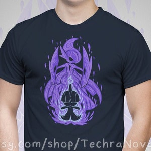 May include: A navy blue t-shirt with a purple graphic of a Pokemon character. The character is surrounded by flames. The text "etsy.com/shop/TechraNova" is printed on the bottom of the shirt.