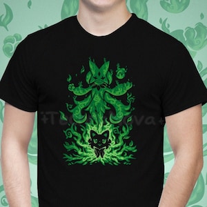 May include: Black t-shirt with a green graphic print of a cat-like creature with flames and leaves. The creature has a large head with a pointed ear and a small body with a tail. The graphic is centered on the shirt.