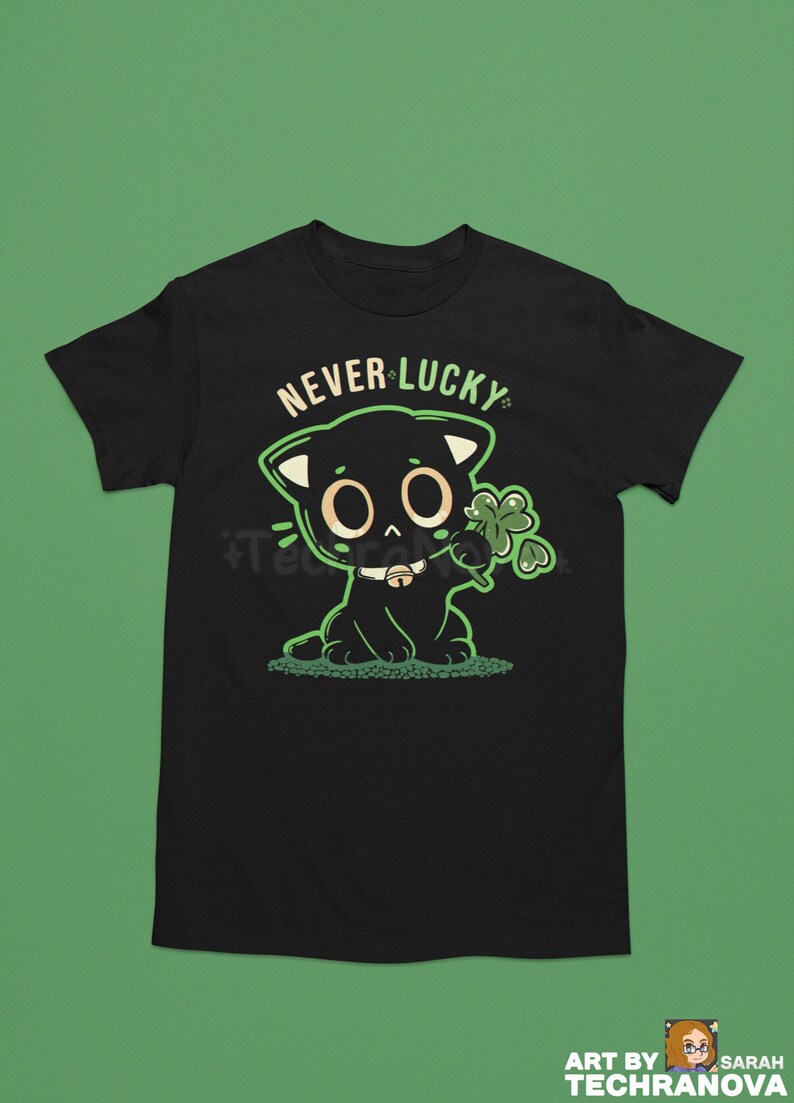 May include: Black t-shirt with a green cartoon cat holding a four-leaf clover. The text "NEVER LUCKY" is above the cat.