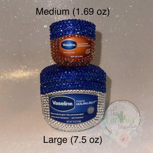 May include: Two sizes of Vaseline Healing Jelly jars, decorated with blue and clear rhinestones. The smaller jar is 1.69 oz and the larger jar is 7.5 oz.
