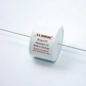 May include: A white cylindrical capacitor with two silver wires extending from it. The capacitor is labeled "M Mundorf MCap EVO Aluminum Oil Made in Germany 10.00 µF ± 2% 450 VDC  REC RoHSREACH 1204".