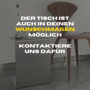 May include: A silver side table with a silver sculpture on top. The text on the table reads "Der Tisch ist auch in deinen Wunschma&szlig;en m&ouml;glich. Kontaktiere uns daf&uuml;r."