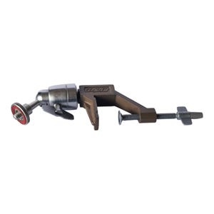 May include: A bronze-coloured metal C-clamp mount featuring a silver-toned ball head attachment. The clamp includes a threaded screw with a wing-style handle for tightening, and the ball head has a circular mounting plate with a red rubber ring.