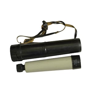 May include: A black and cream spotting scope with a black case and a leather strap. The spotting scope has the text "TYPИCT-3 20x50" printed on the side. The scope is designed for viewing distant objects.
