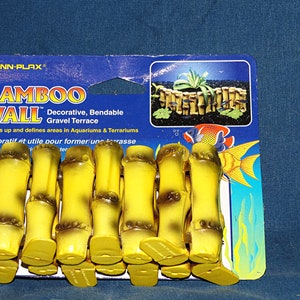 May include: A package of yellow and brown plastic bamboo wall pieces for aquariums and terrariums. The package says "Bamboo Wall" and "Decorative, Bendable Gravel Terrace".