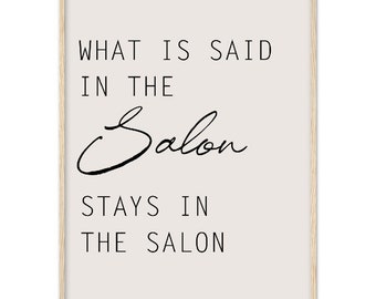 May include: A white framed print with black text that reads "What is said in the Salon stays in the Salon".