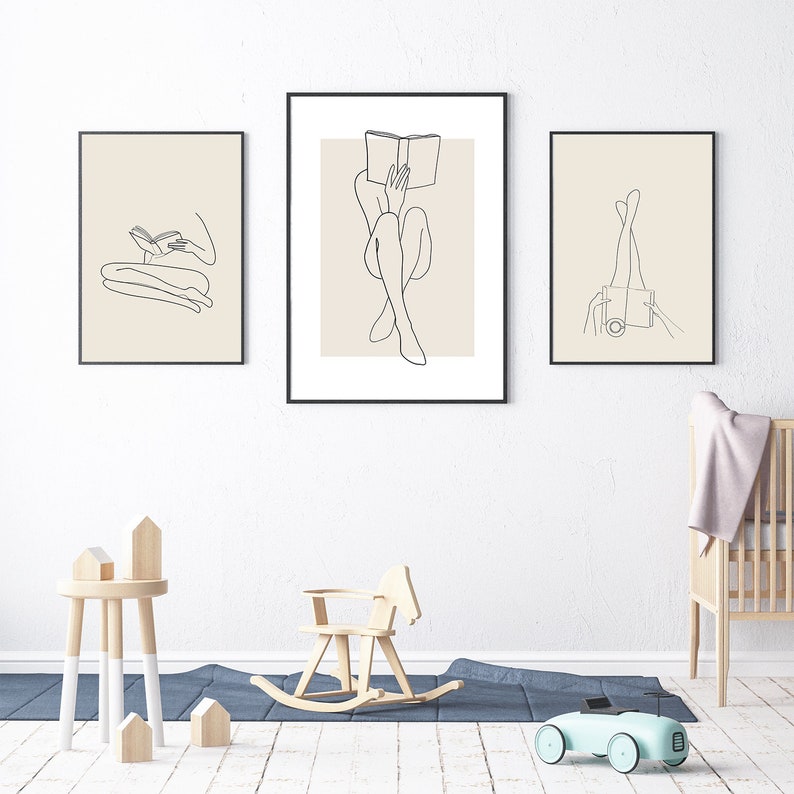 May include: Three black framed illustrations of line drawings of a person sitting and reading a book, a person sitting with legs crossed and a person with legs up in the air.