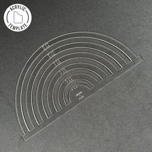 May include: A clear acrylic template with a rainbow of circles, labeled with their outer diameters in inches. The template is designed for crafting and includes a center point.