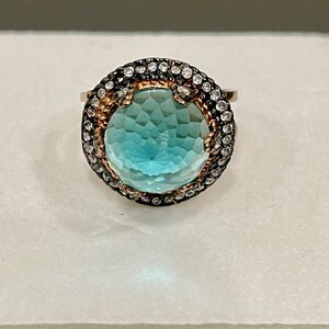 Sterling Silver Blue Topaz Ring With A Rose Gold Finish And Black Rhodium