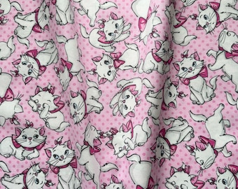 May include: Fabric with a repeating pattern of white cartoon cats with pink bows on a pink background with small white polka dots. The cats are in various poses, some sitting, some lying down, and some standing.
