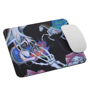 May include: A black mouse pad with a colorful illustration of a skeletal horse with wings, a skull, and flowers. The illustration is done in colored pencil.