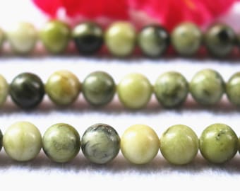 May include: Strands of round, green gemstone beads. The beads vary in shades of green, from light to dark, with some having a marbled appearance. The beads are strung together, suggesting they are for jewelry making or crafting.