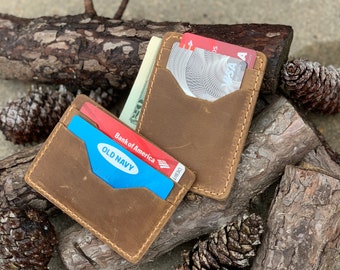 May include: A brown leather wallet with a flap closure and multiple card slots. The wallet is filled with cards, including a Bank of America debit card and an Old Navy card.