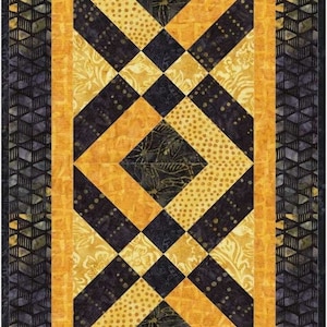 May include: A black and gold quilt with a diamond pattern. The quilt has a border of black and gold fabric.
