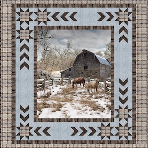 May include: A quilt featuring a central photographic print of two horses in a snowy field with a wooden barn. The border consists of light blue fabric with dark brown geometric star and chevron patterns, framed by a tan and brown plaid fabric.