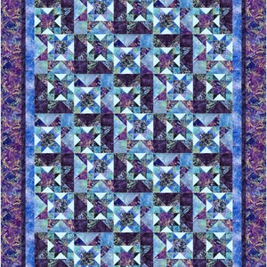 May include: A quilt with a blue and purple star pattern. The quilt is made up of many smaller squares, each with a different design. The quilt is surrounded by a border of a darker blue color.