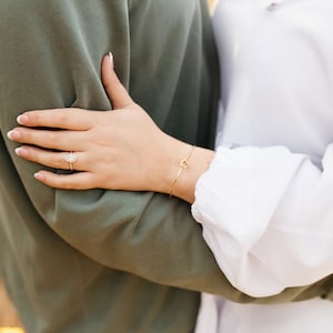 This photo features the bride wearing it. Not only is the bracelet perfect for Bridesmaids, Maid of Honors, Junior Bridesmaids, Matron of Honors, Flower girls, but it's also perfect for the bride so she can match with her bridal party.