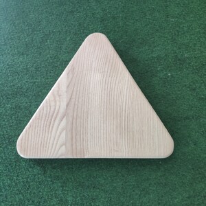 May include: A triangular wooden serving tray with a light wood grain finish.