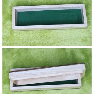 May include: A wooden box with a hinged lid. The box is lined with green felt. The lid is open and the box is empty.