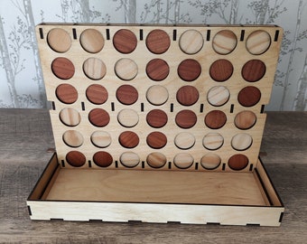 May include: A wooden Connect Four game with a brown wooden base and a brown and natural wood playing board. The board has 7 columns and 6 rows of circular holes. The game is set up with red and natural wood pieces.
