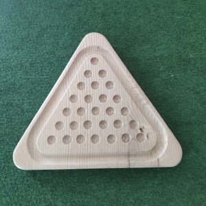 May include: A wooden triangular game board with a pattern of circular holes. The board is made of light wood and has a smooth surface.