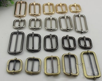 May include: Assortment of metal slider buckles in various sizes and finishes, including gold, silver, black, and antique brass.