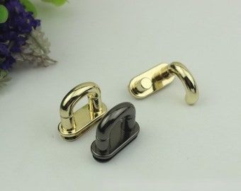 May include: Three metal hardware pieces for bags or other crafts. Two are gold-toned and one is black. One gold piece is a D-ring, one gold piece is a hook, and the black piece is a D-ring.