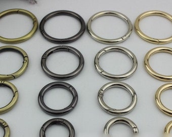 May include: Assortment of 16 silver, gold, and black metal key rings with a spring clasp. The key rings are various sizes.