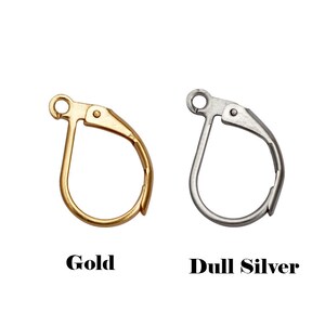 May include: Two earring hooks, one gold and one silver. The hooks are made of metal and have a simple, classic design.