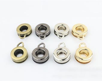 May include: Eight metal rings with a loop on top. The rings are in four different finishes: gold, silver, antique brass, and black.