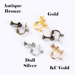 May include: Four pairs of earring clips in different finishes: antique bronze, gold, dull silver, and KC gold.