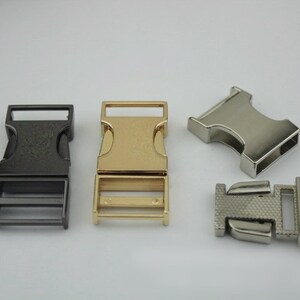 May include: Four metal buckle closures in different finishes: black, gold, silver, and a brushed silver. The buckles are designed for use with webbing or straps.