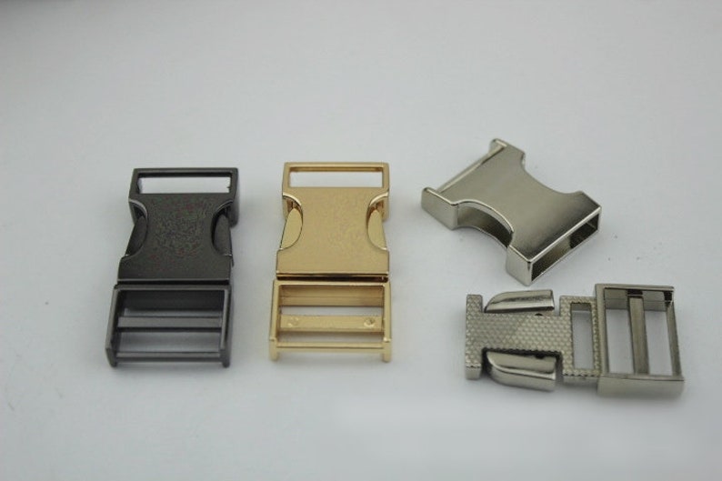 May include: Four metal buckle closures in different finishes: black, gold, silver, and a brushed silver. The buckles are designed for use with webbing or straps.