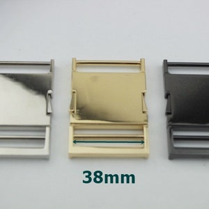 May include: Three metal belt buckle sliders in silver, gold, and black. Each slider measures 38mm in length.