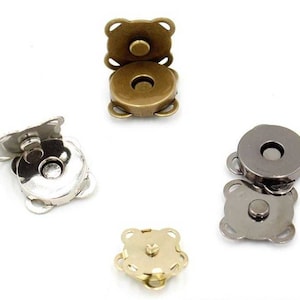 May include: Four magnetic snap closures in different finishes: gold, silver, and gunmetal. Each closure has a round button and four prongs.
